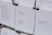 Several sheets of paper clipped together display various poems. The visible pieces contain poems discussing themes such as war, peace, and wishes for a better future. The text is printed in a clean, minimalistic font against a white background, with black clips at the top securing the sheets.