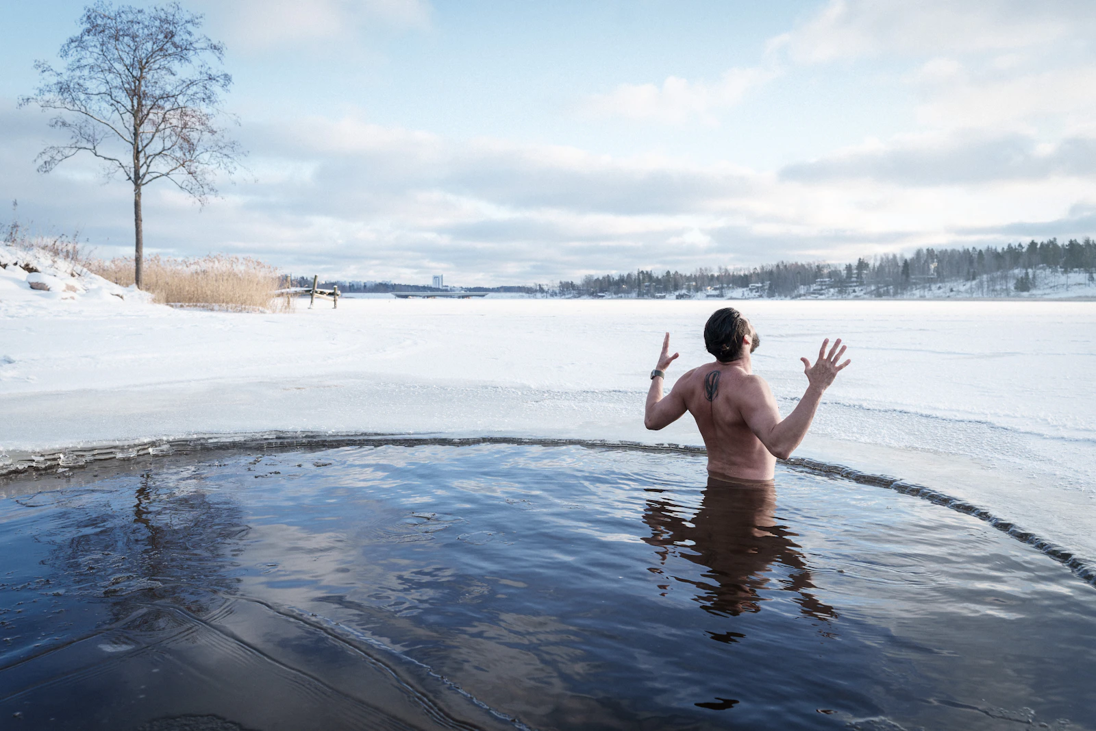 Person emerging from a cold plunge in winter