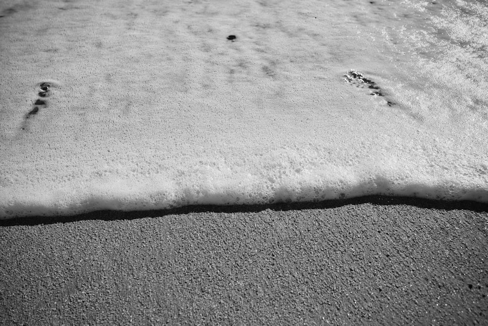 a black and white photo of footprints in the snow