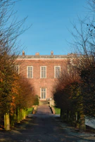 An outdoor shot of the institute’s building with black and gold accents under a clear sky.