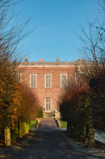 An outdoor shot of the institute’s building with black and gold accents under a clear sky.