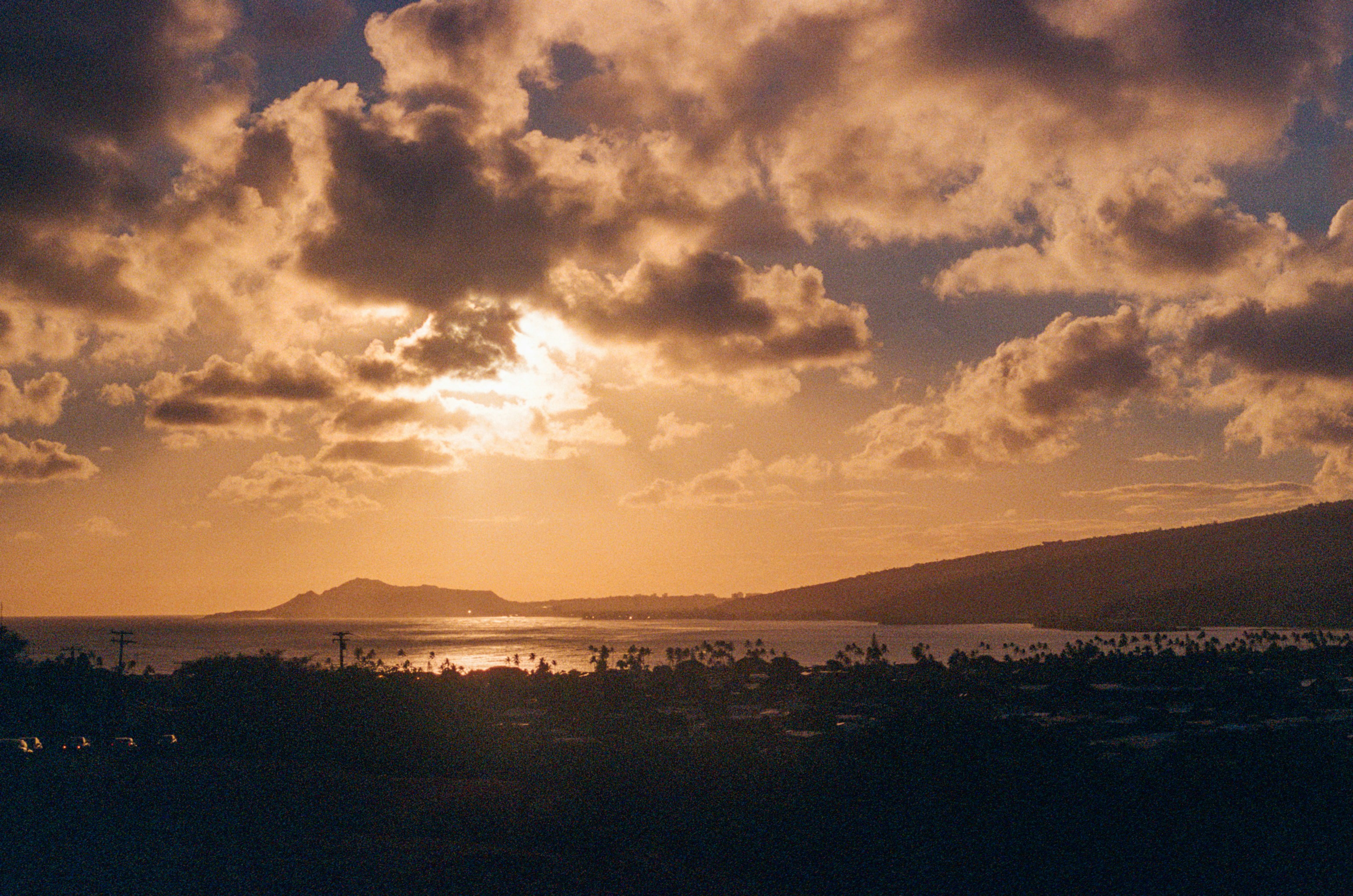 the sun is setting over a body of water