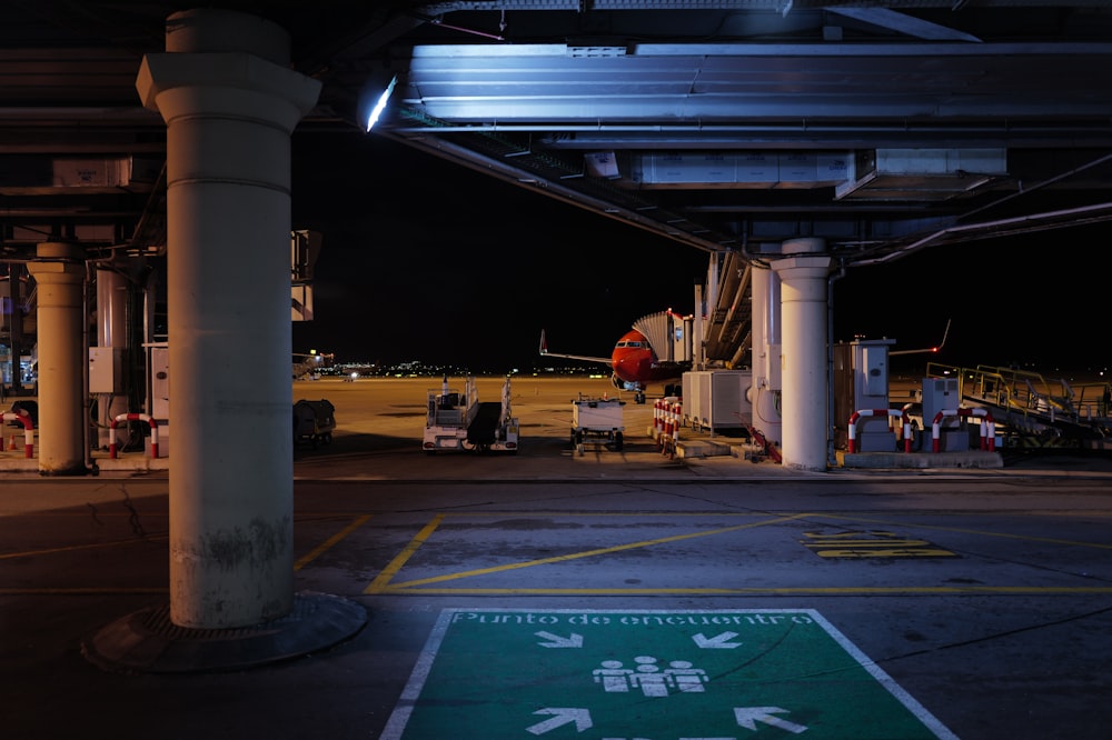 an airport parking lot with a green sign on the ground