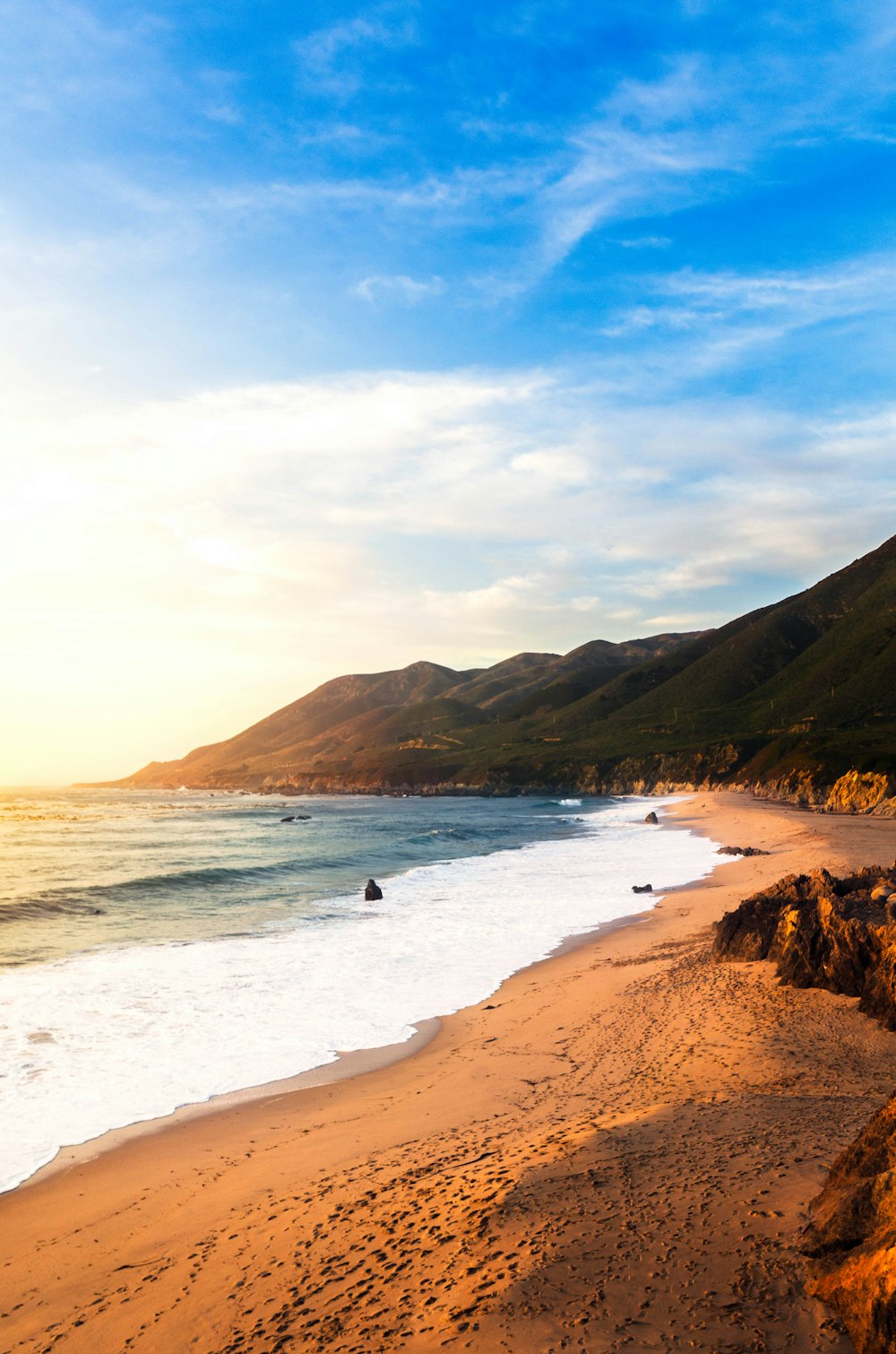 a view of a beach with a mountain in the background