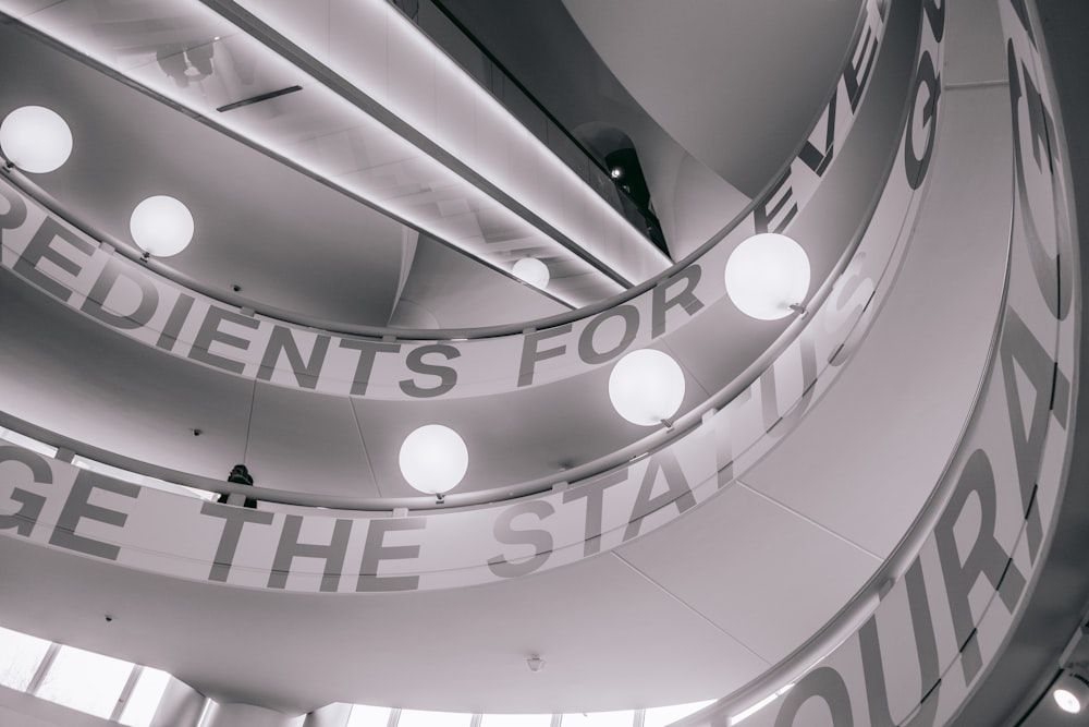 a spiral staircase with lights and a sign on it
