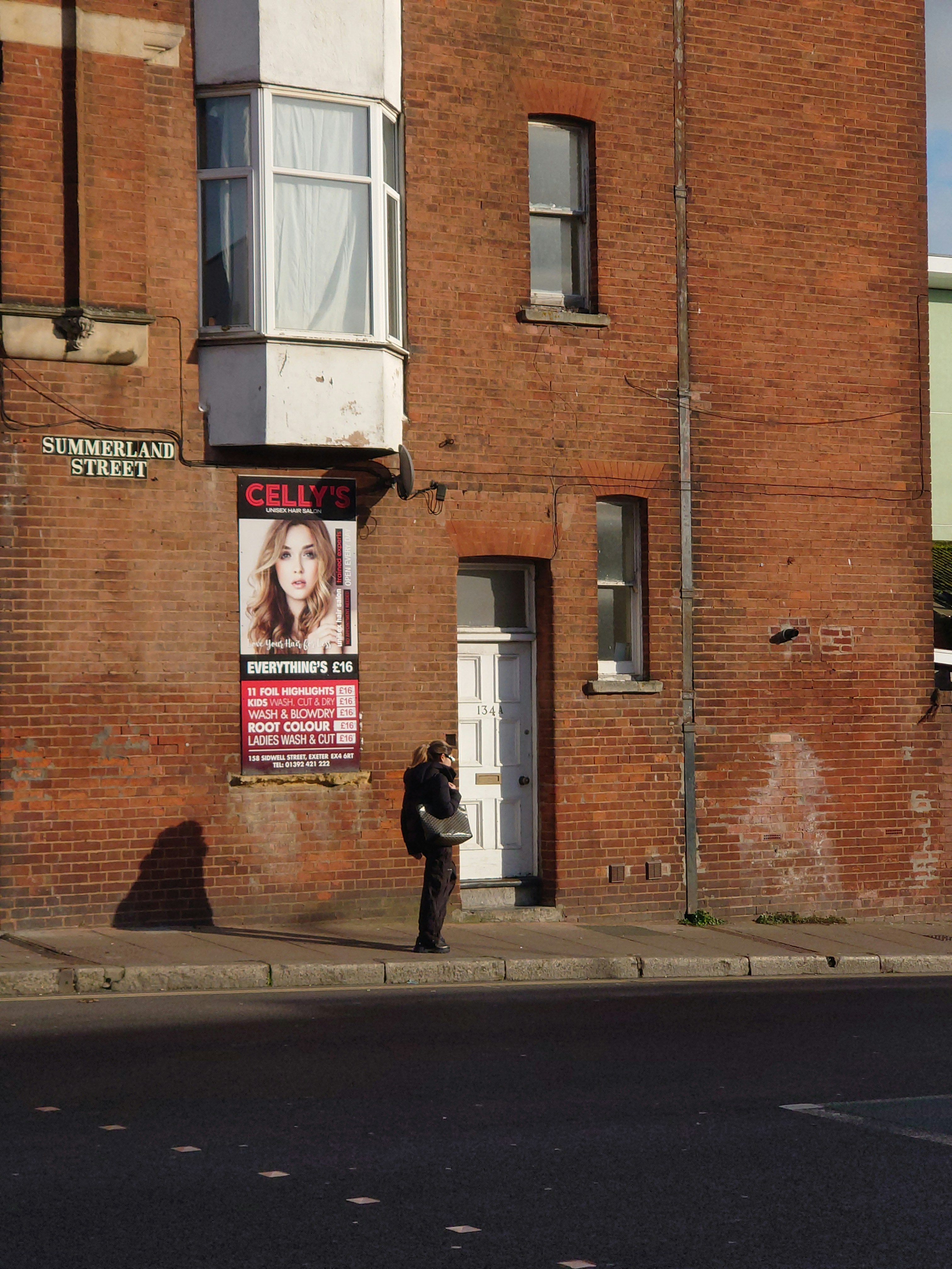 a person standing in front of a brick building