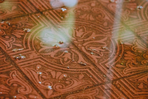 Close-up of a beautifully restored bathroom tile floor with glossy finish.