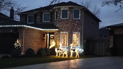 A beautifully decorated home with elegant Christmas lights illuminating the exterior.