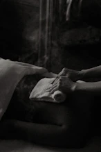 a black and white photo of a person laying in a bed