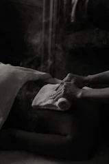 a black and white photo of a person laying in a bed
