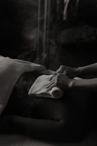 a black and white photo of a person laying in a bed