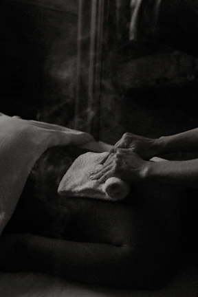 a black and white photo of a person laying in a bed