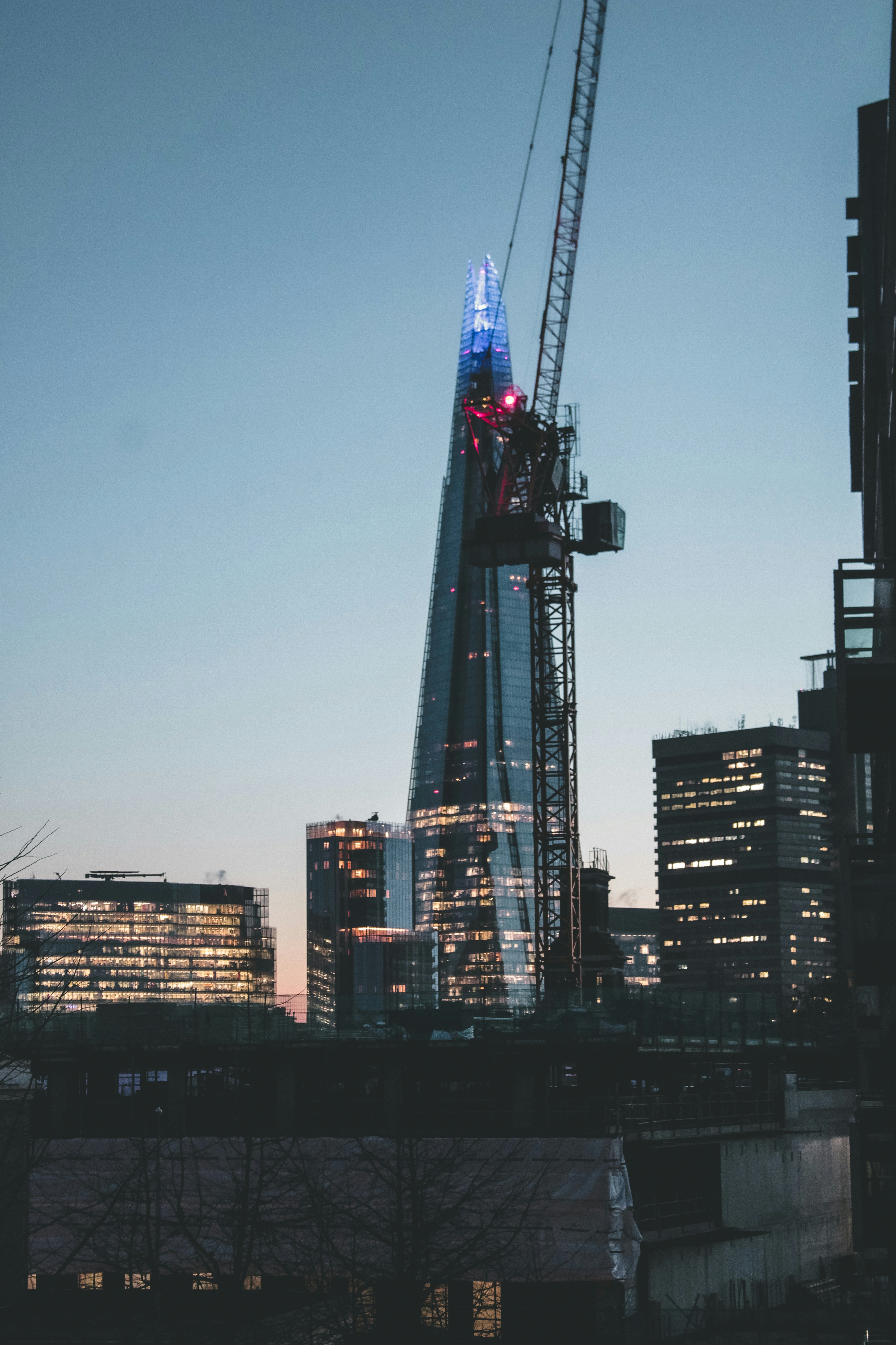 the shard of the building is lit up in red, white, and blue