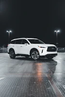 Side view of a sparkling white SUV parked outside a Fort Worth home.