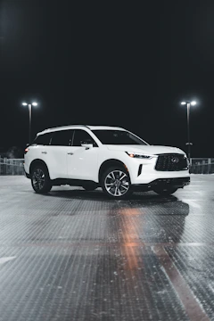 A sparkling SUV parked outside Dreamy Shines Auto Care shop.