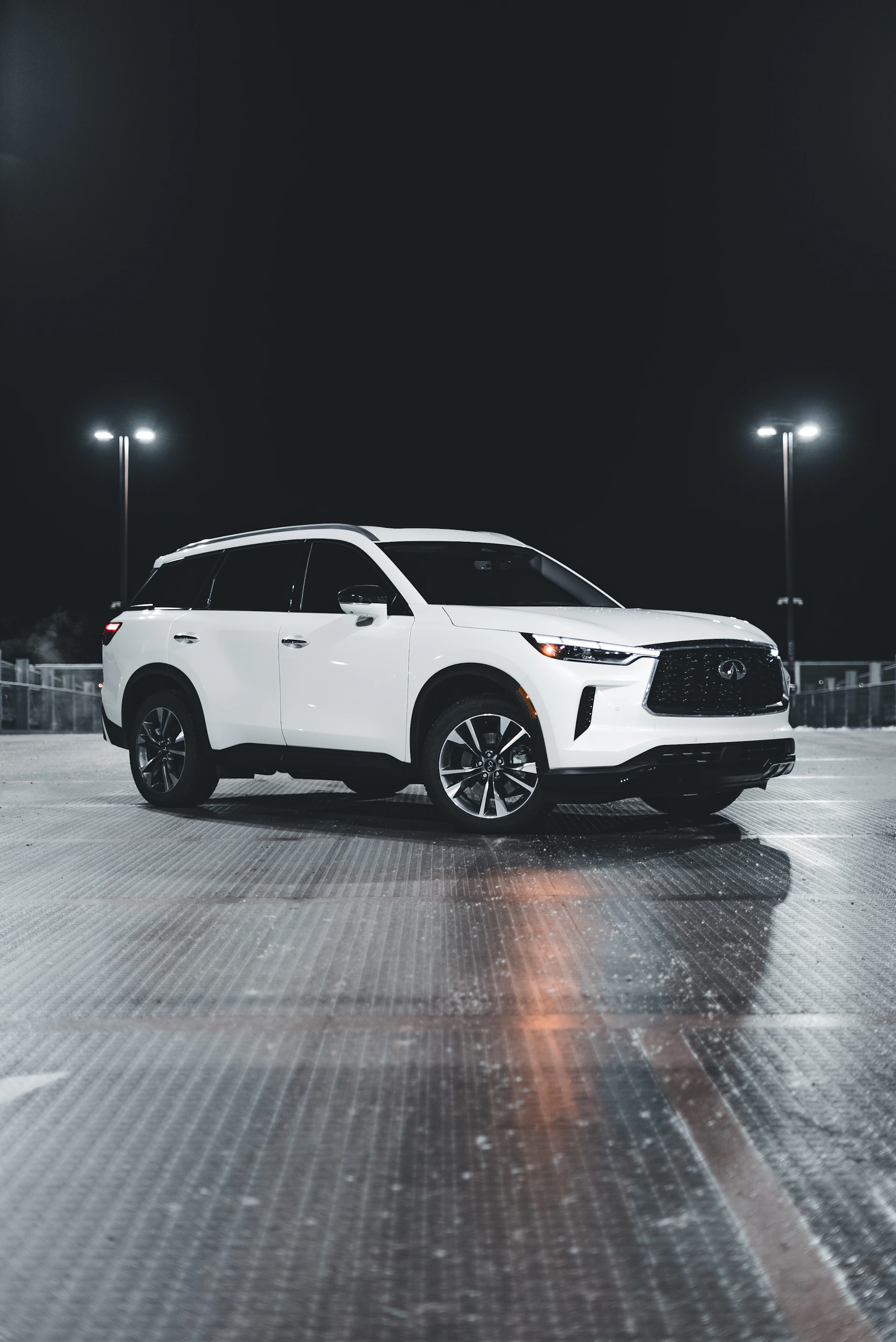 A pristine white SUV parked by a modern home, its surfaces reflecting the clean, silver-toned surroundings.