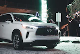 A fleet of luxury vehicles lined up on a snowy Quebec street, showcasing elegance in winter.