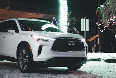 A fleet of luxury vehicles lined up on a snowy Quebec street, showcasing elegance in winter.