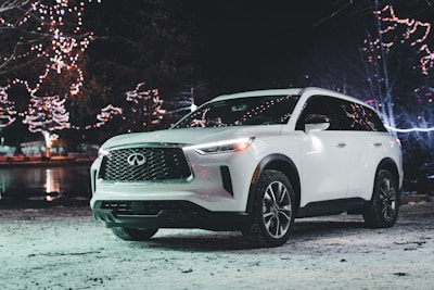 Excited winner celebrating next to their new Skoda Superb 4x4 in a festive setting.