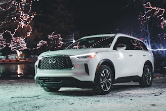 Excited winner celebrating next to their new Skoda Superb 4x4 in a festive setting.