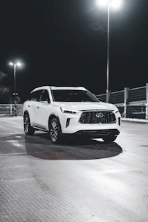A white SUV with sparkling clean tires and polished bodywork under natural light