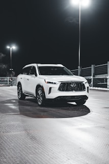 Shiny white SUV showcasing flawless paint protection film with water beading on the surface.