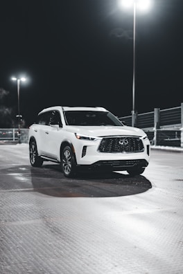 A sparkling white SUV freshly detailed, reflecting the studio’s clean environment.