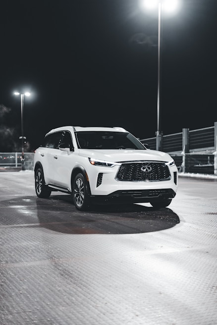 A white SUV with gleaming ceramic coating reflecting the cloudy sky