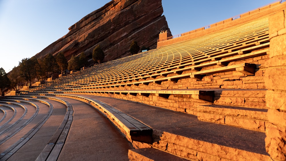 a row of seats sitting on top of a stone wall