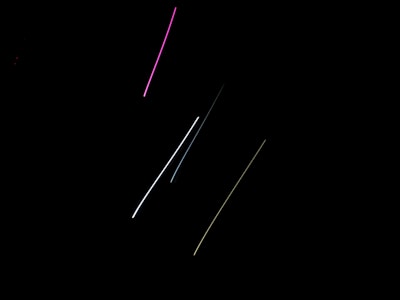 Abstract vertical streaks of pale pink and lavender light fading into darkness.