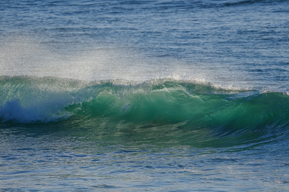 a man riding a wave on top of a surfboard