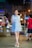 a woman walking down a street at night
