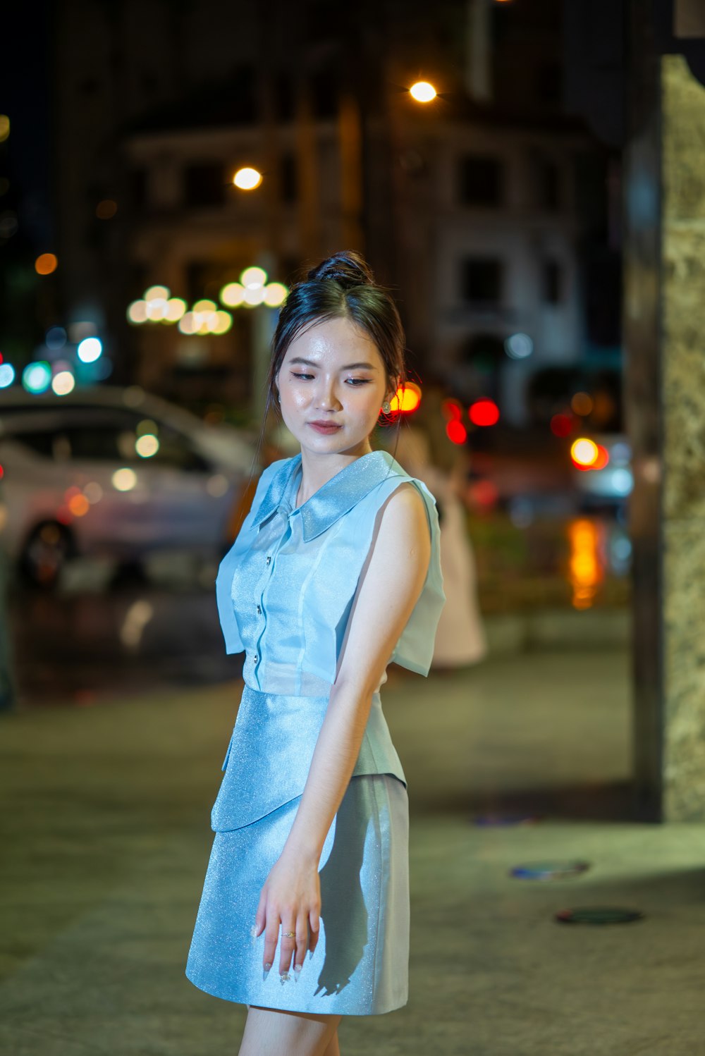 a woman in a blue dress posing for a picture