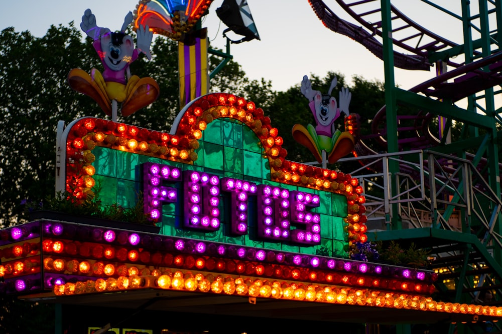 a sign that says eat out on top of a carnival ride