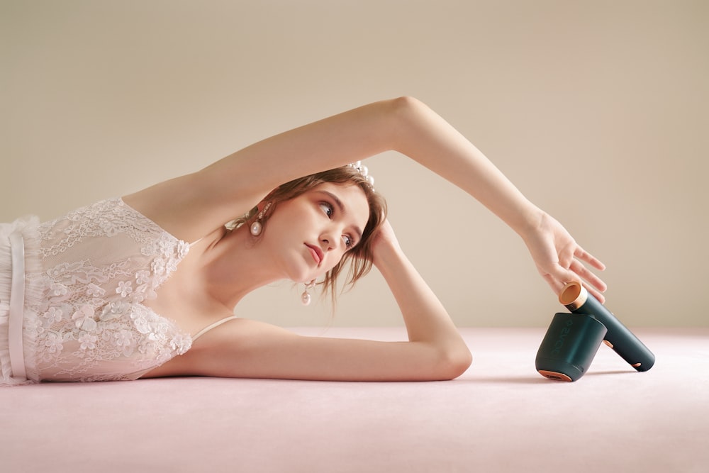 a woman laying on the ground with a pair of shoes