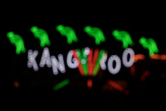 A lively kangaroo mascot holding raffle tickets with a backdrop of shiny cars and cash prizes.