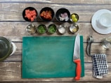 A snapshot of my mise en place setup, showing knives, ingredients, and prep bowls.