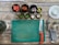A sleek stainless steel kitchen table with fresh vegetables and cooking utensils arranged on top.