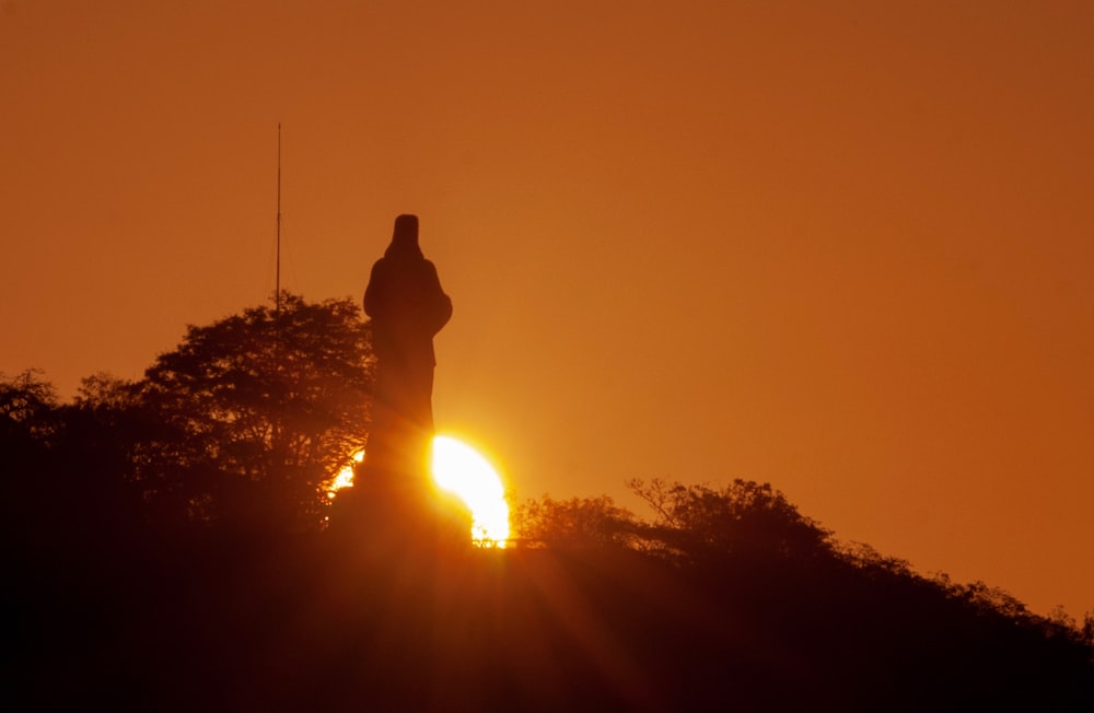 the sun is setting behind a clock tower