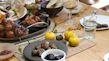 Close-up of vibrant fresh fruits and nuts arranged on a rustic wooden table.