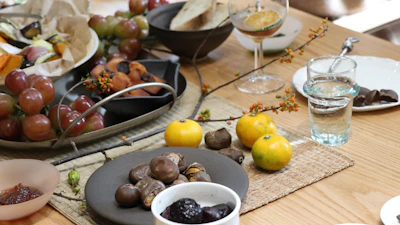Fresh fruits and healthy snacks arranged on a wooden table, representing wellness and nutrition.