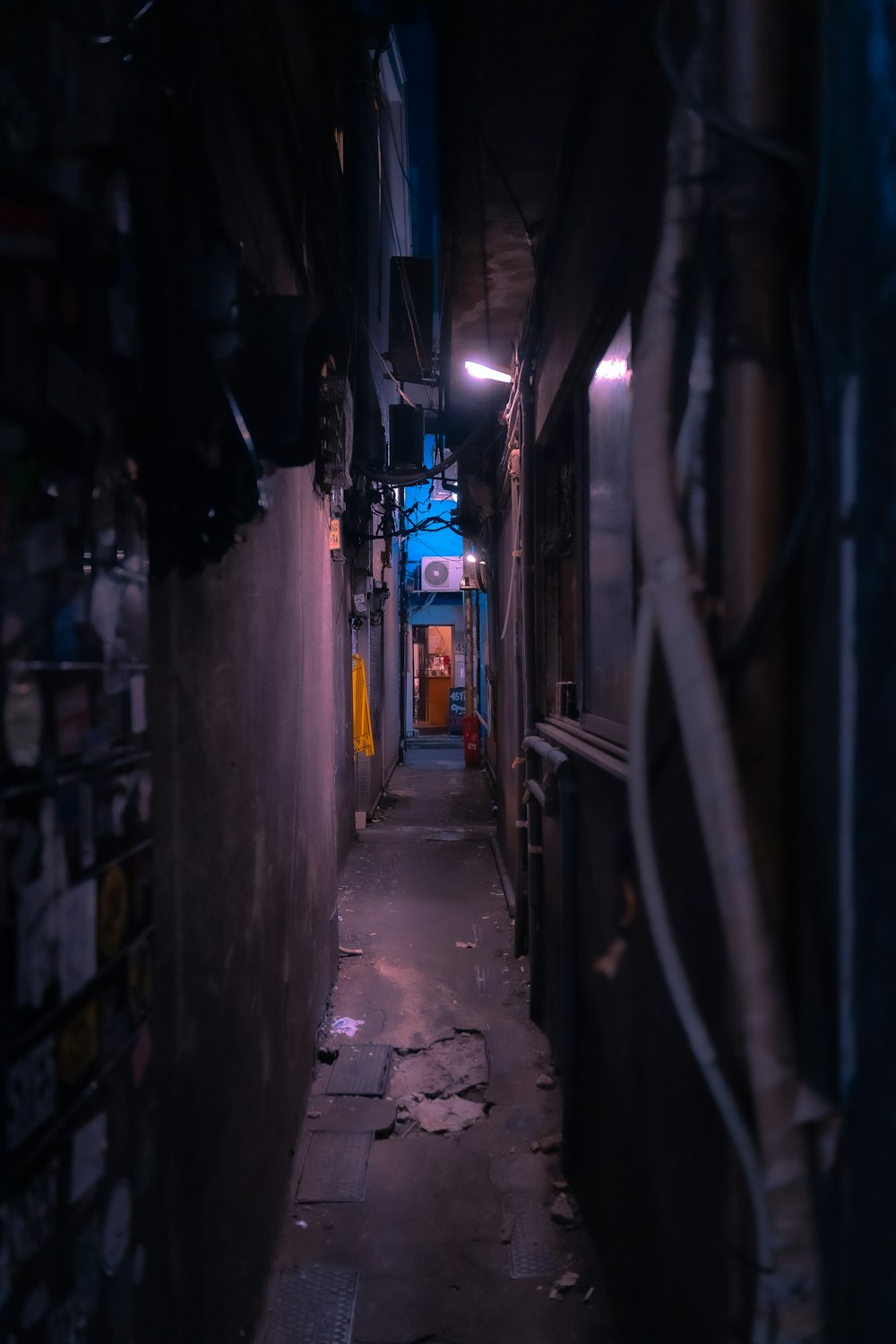 a narrow alley way with a sign on the wall