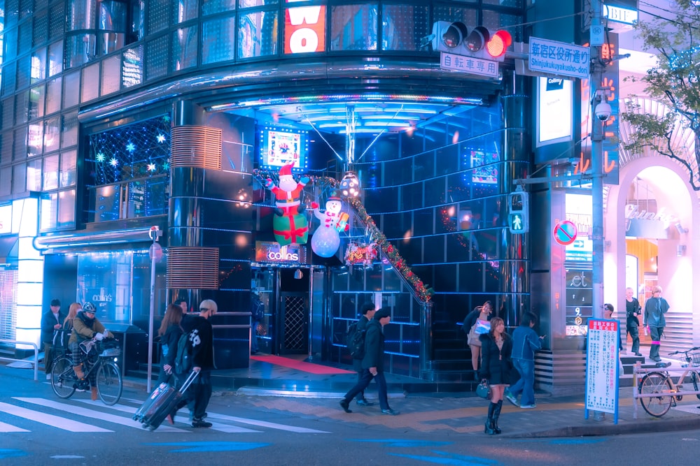 a group of people crossing a street at night