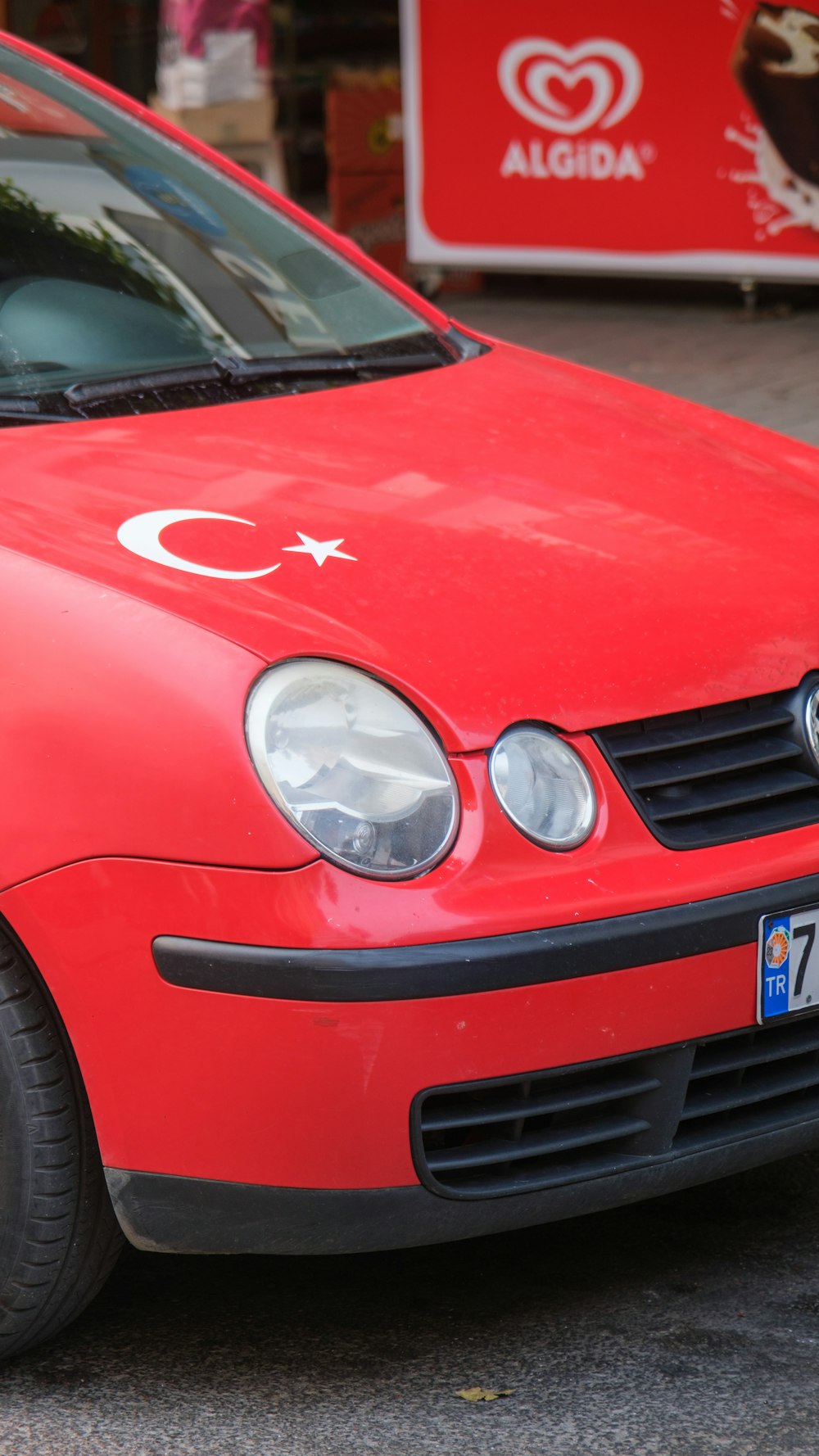 a red car parked on the side of the road