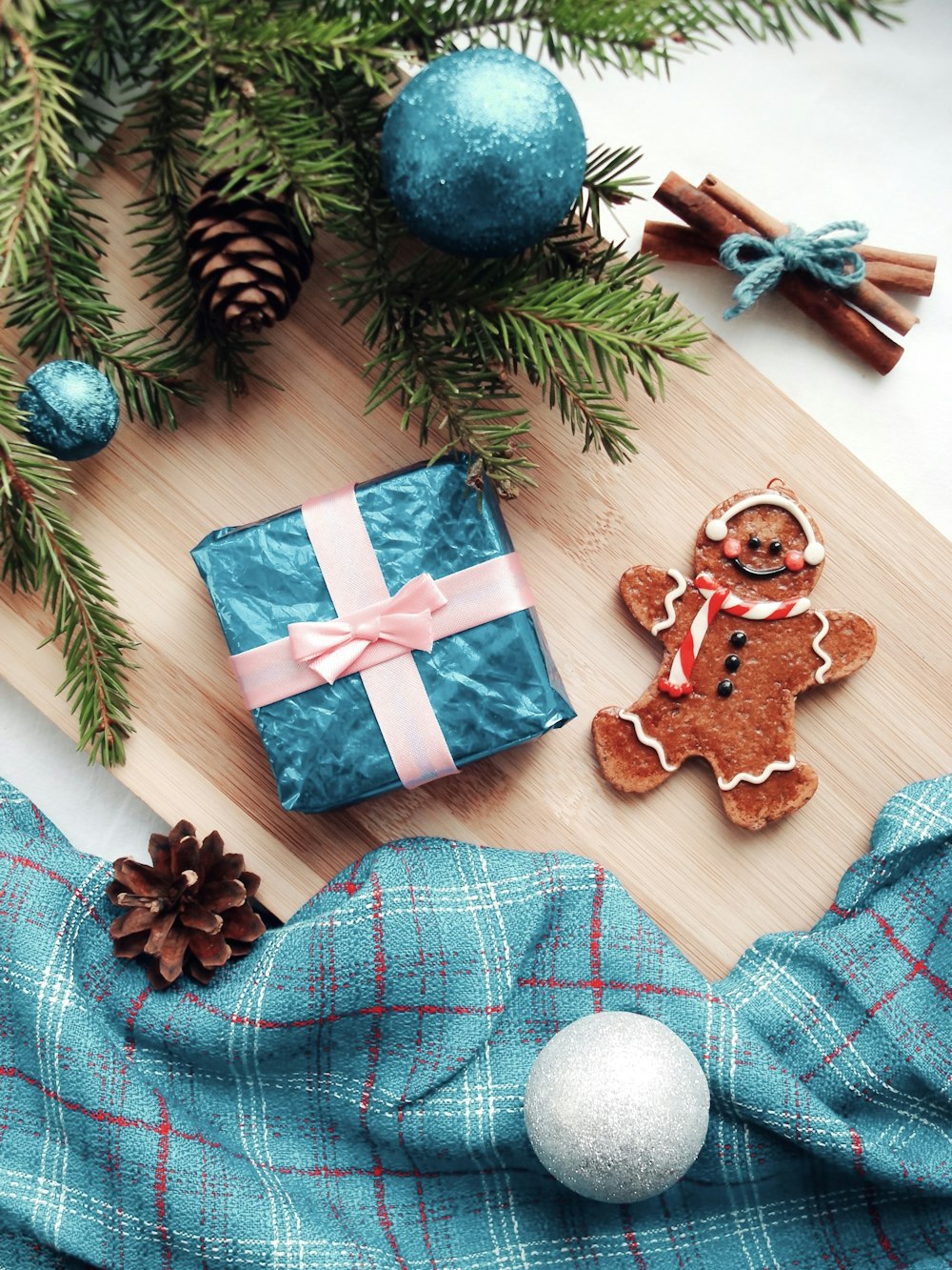 a wooden cutting board topped with christmas decorations