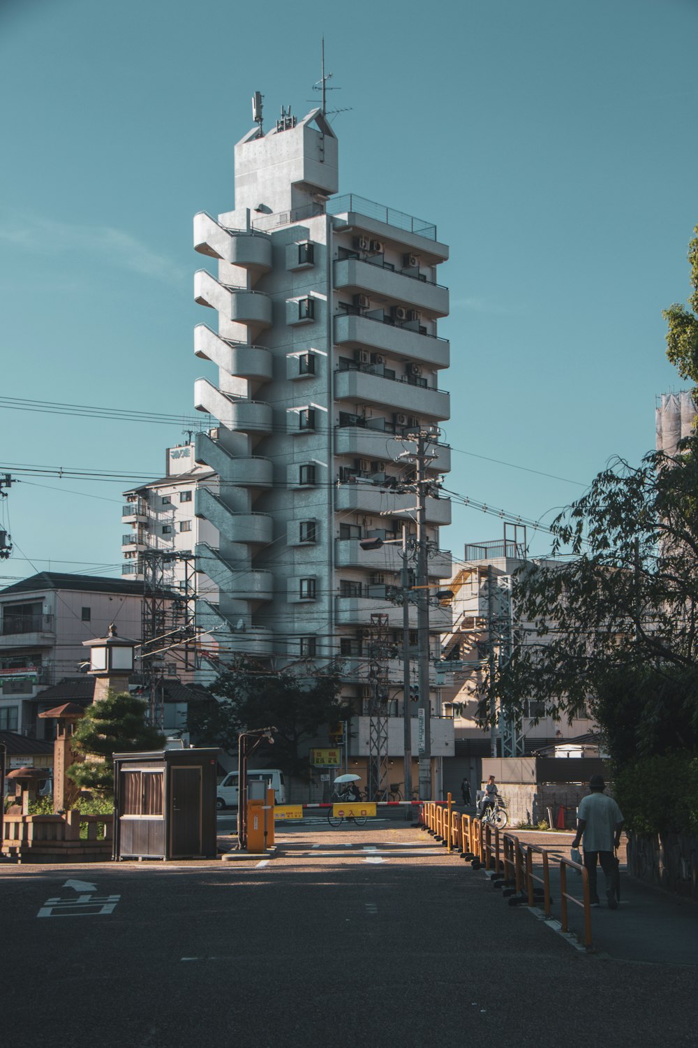 a tall white building sitting on the side of a road