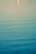 A calming encaustic artwork featuring soft blues and greens inspired by river reflections.