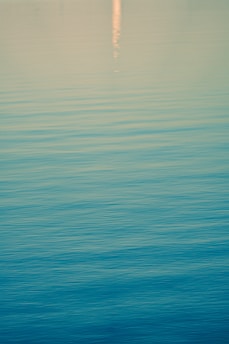 A calming encaustic artwork featuring soft blues and greens inspired by river reflections.