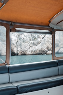 Interior seating area of a speedboat showing comfortable cushioned seats and sunshade.
