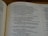An open book displaying text content from 'The Books of the Prophets.' The text discusses themes of idolatry, spiritual infidelity, and divine punishment. The page number shown is 677. The book is placed on a wooden surface.